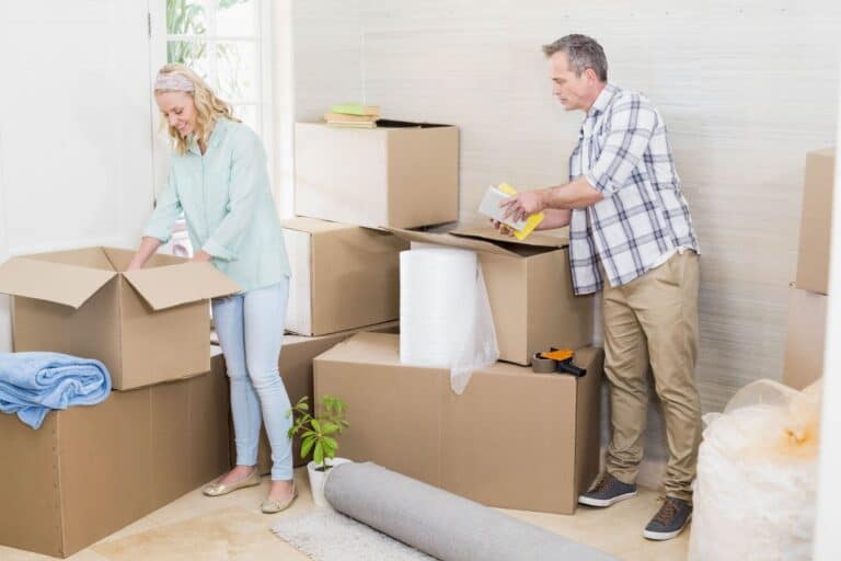 A mature couple packing their things for relocation
