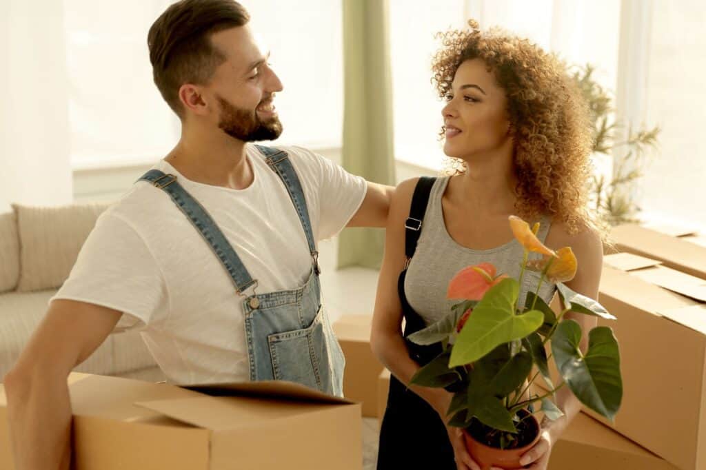 Newlyweds in their new apartment in the concept of relocation