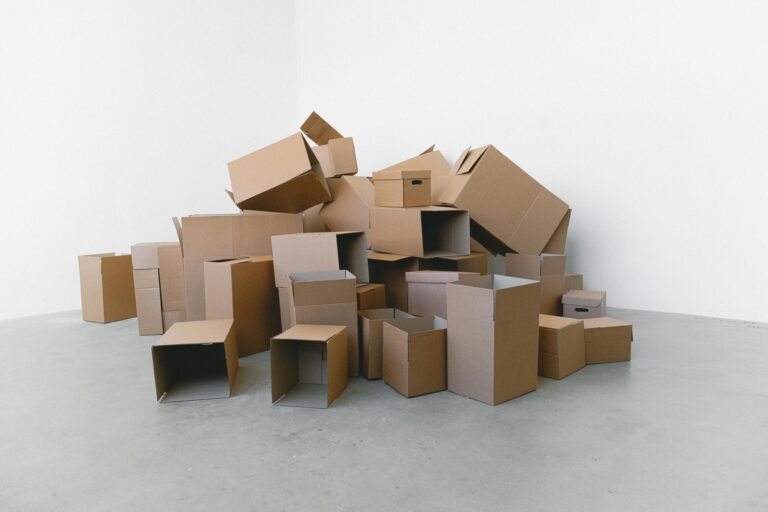 Empty cardboard boxes in the corner of the room in the concept of man and van in Ealing.