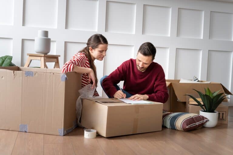 A young couple preparing for the house relocation in the concept of 'How to Plan and Prepare for Home Removals'.