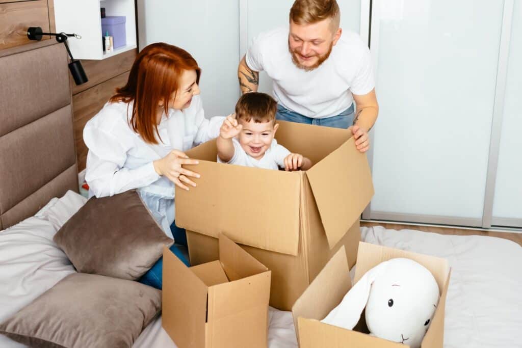 A young family unpacking in the bedroom