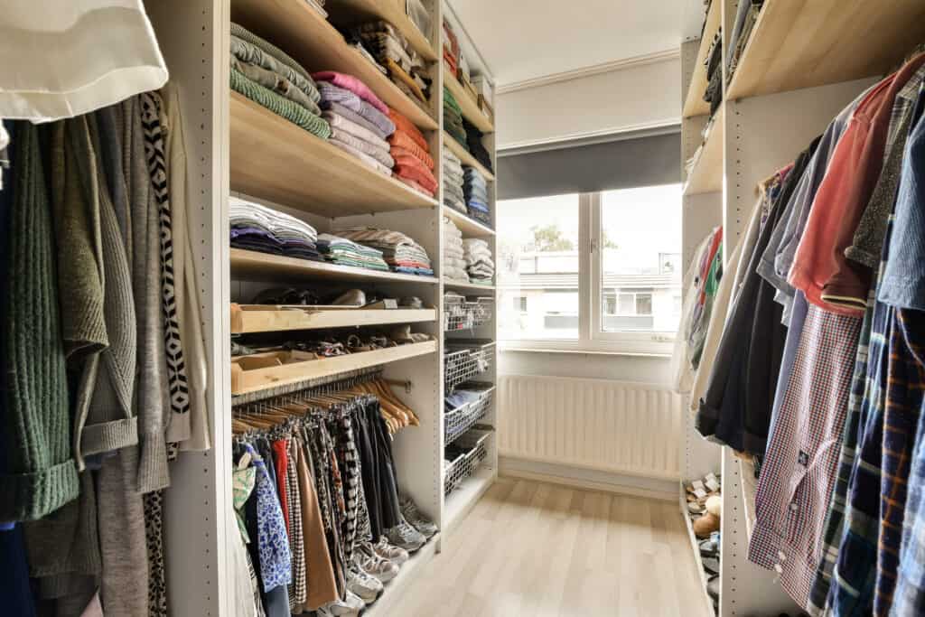 A walk-in closet filled with clothes that a man and van can help pack quickly